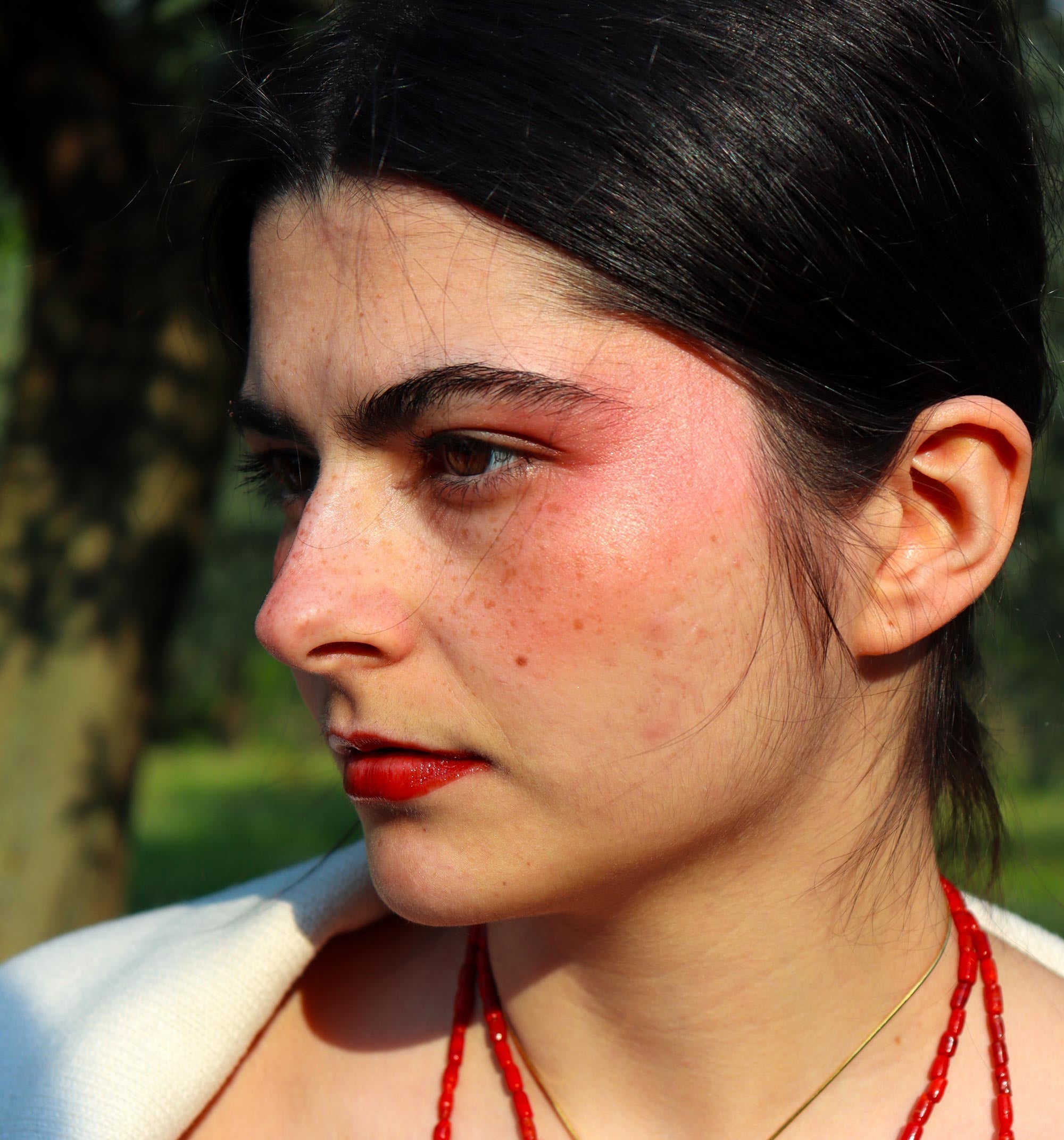 Woman wearing Lebubè's Lip and Cheek to recreate a sunset blush look, replicating the warm hues of summer sunset