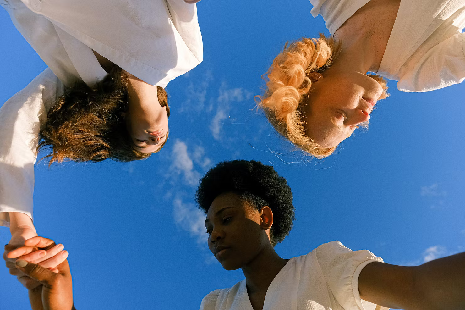 Three girls dancing in a circle, symbolizing inclusivity, diversity, and sustainability, the core values of Lebubè's blog.
