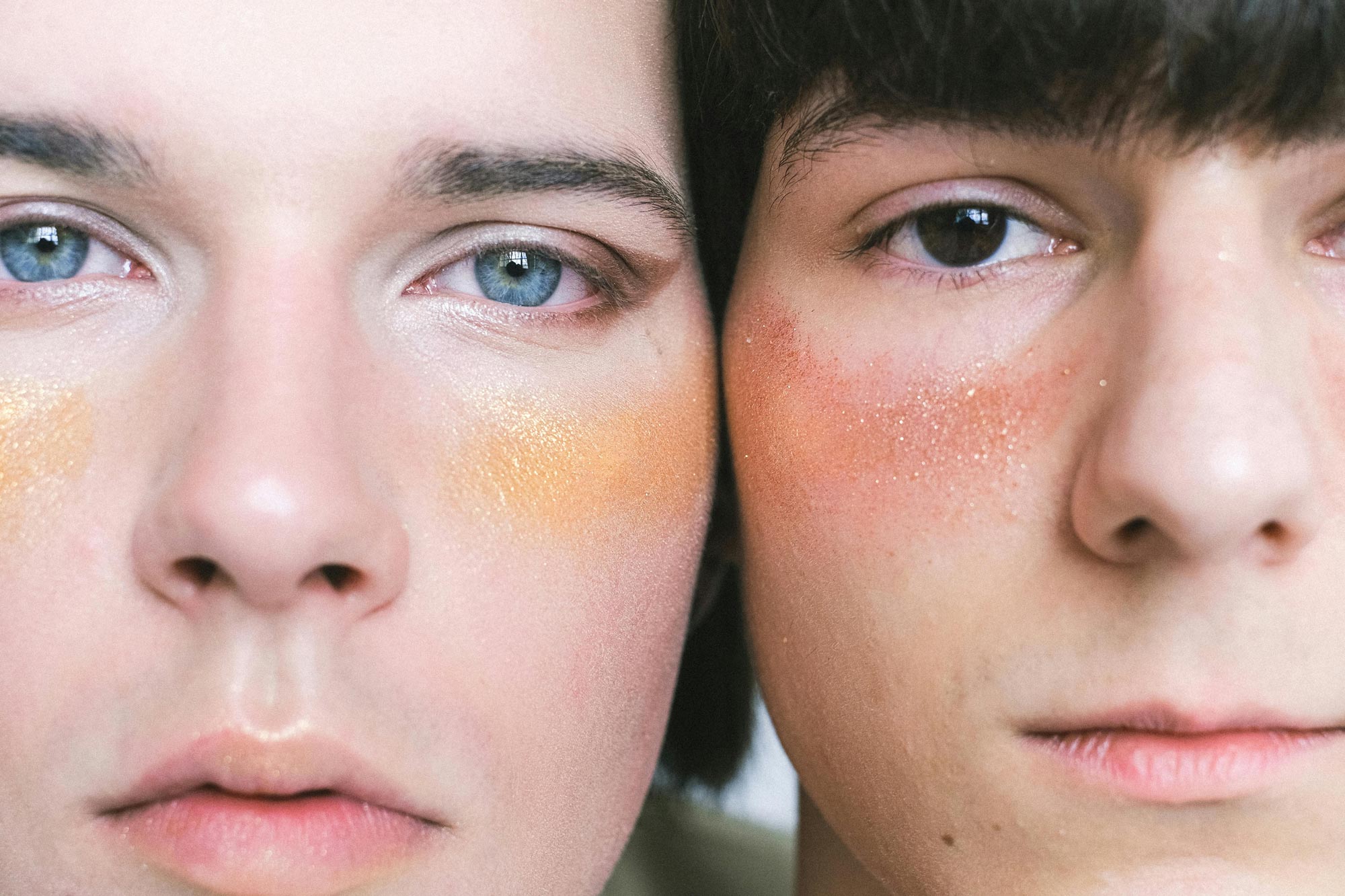 Two men side by side wearing makeup, symbolizing the true self, gender fluidity, challenging beauty standards.