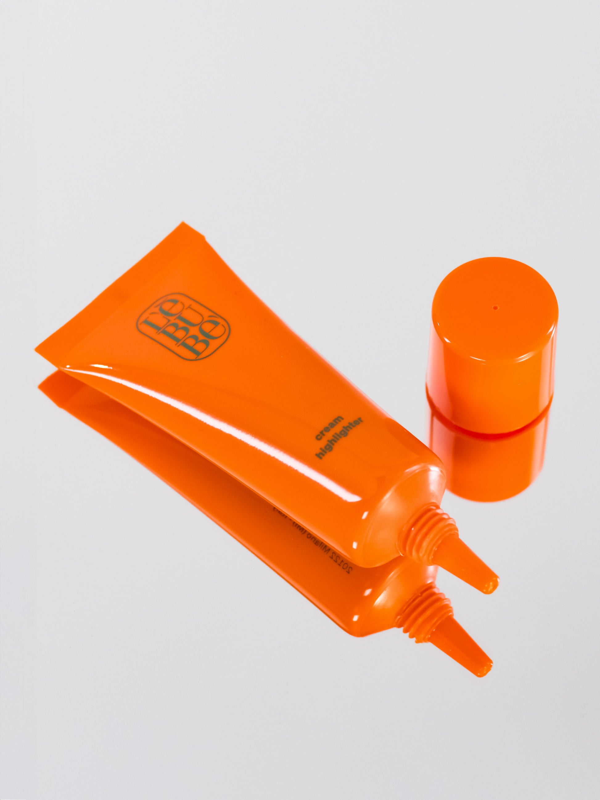 Lebubè Cream Highlighter: glowing, refreshing, hydrating highlighter. Lying down, open, no cap. From Lebubè hybrid cosmetics.