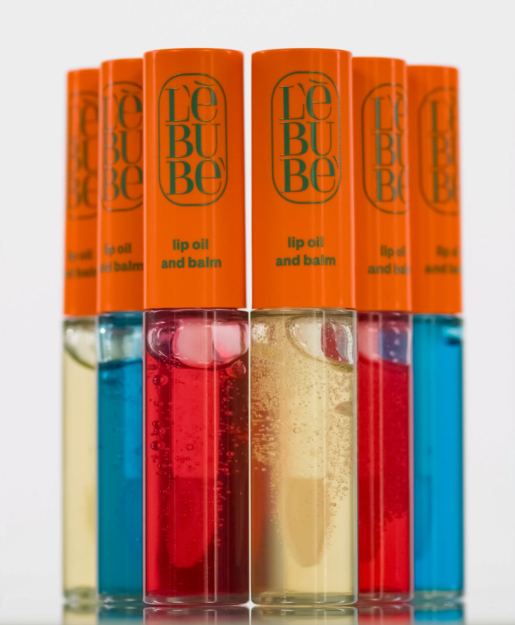 Lebubè Lip Oil and Balm: hydrating lip oil and balm for glossy look. Three shades, front view. From Lebubè hybrid cosmetics.