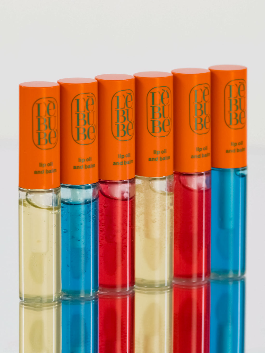 Six Lebubè hydrating Lip Oil and Balm, front view. Peptide lip treatment from Lebubè vegan and natural hybrid cosmetics