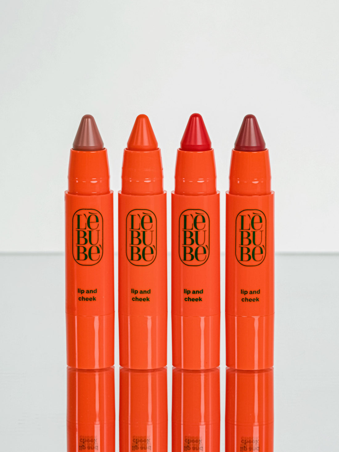 LIpstick and blush from Lebubè vegan and natural hybrid cosmetics. Four inclusive shades for all skin tones, front view.