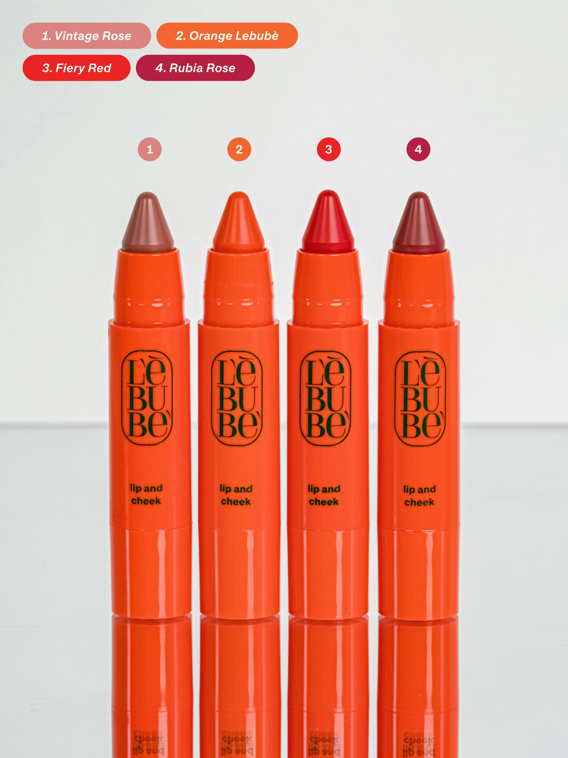 Four Lebubè Lip and Cheek with color swatches above, front view. Lipstick and blush in one, from Lebubè hybrid cosmetics