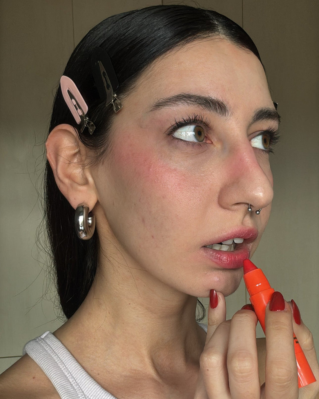 Woman wearing Lebubè Lip and Cheek natural blush and lipstick in Fiery Red on cheeks and lips. From Lebubè hybrid cosmetics.