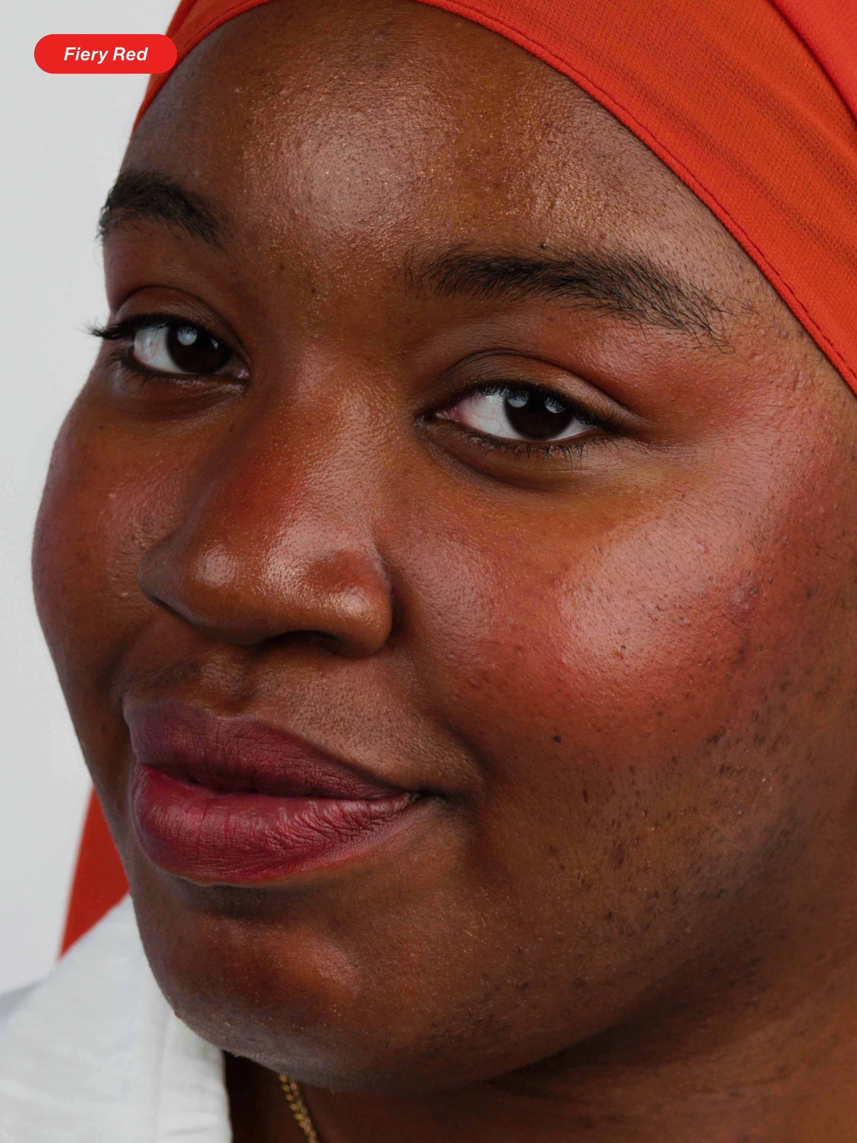 Woman wearing Lebubè multifunctional vegan and Halal lipstick and blush with natural ingredients in Fiery Red, with bold look