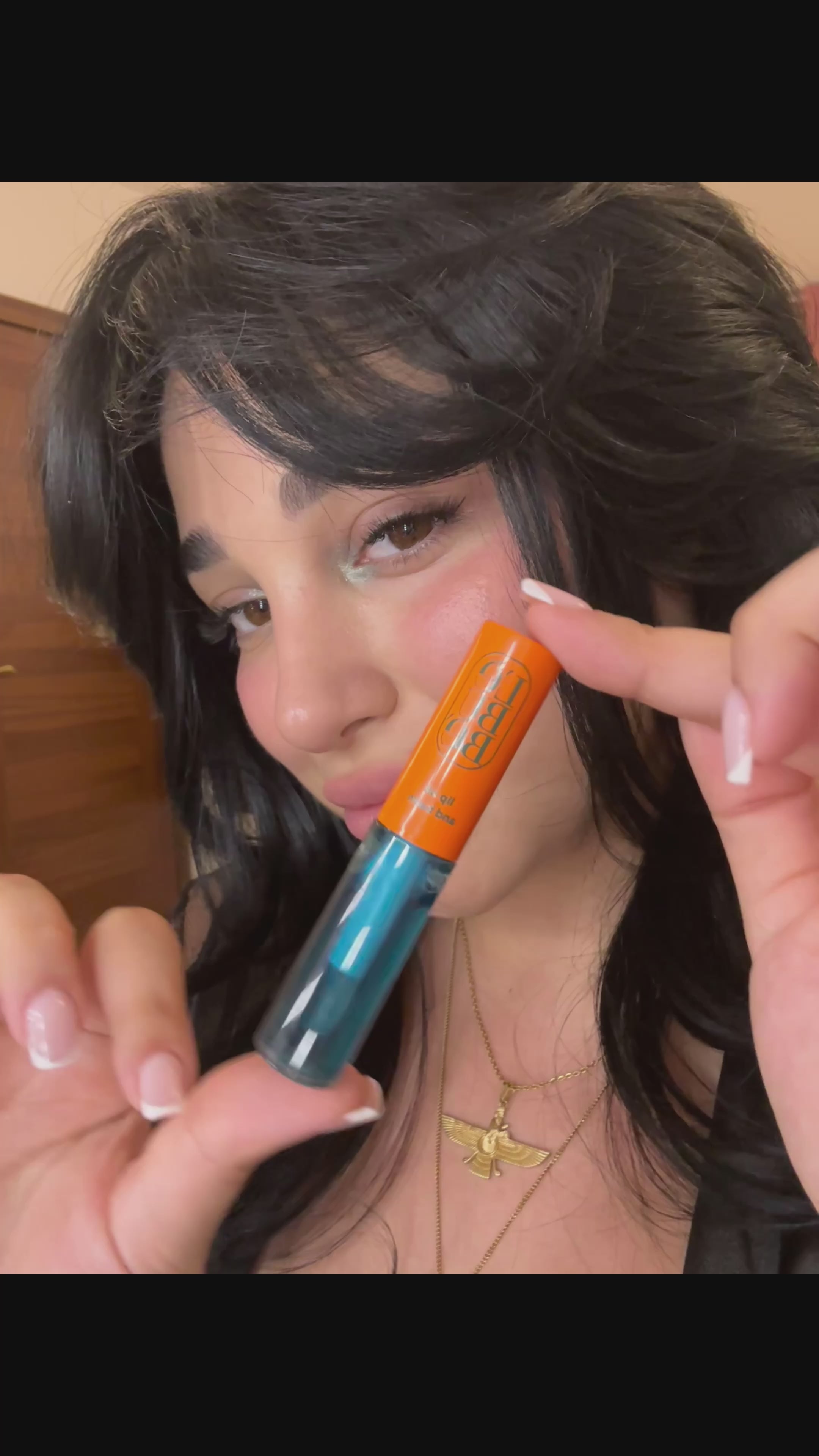 Load video: Woman applying the Halal, vegan, natural and hydrating Lip Balm in Azure, for lip care and treatment to protect dry lips