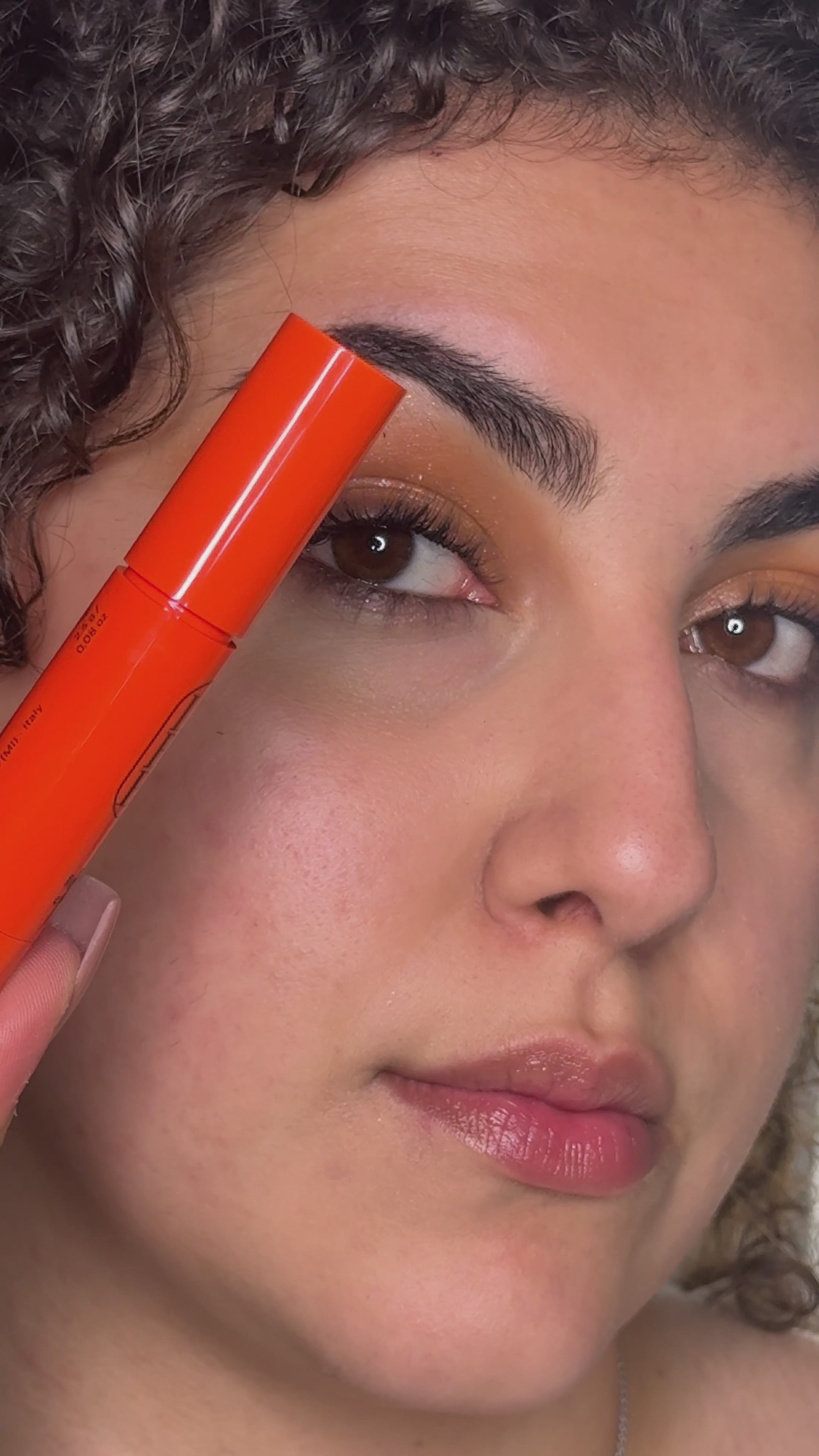 Load video: Woman wearing the multifunctional orange Lip and Cheek on lips, cheeks and eyelids for a sunset blush and sun-kissed look