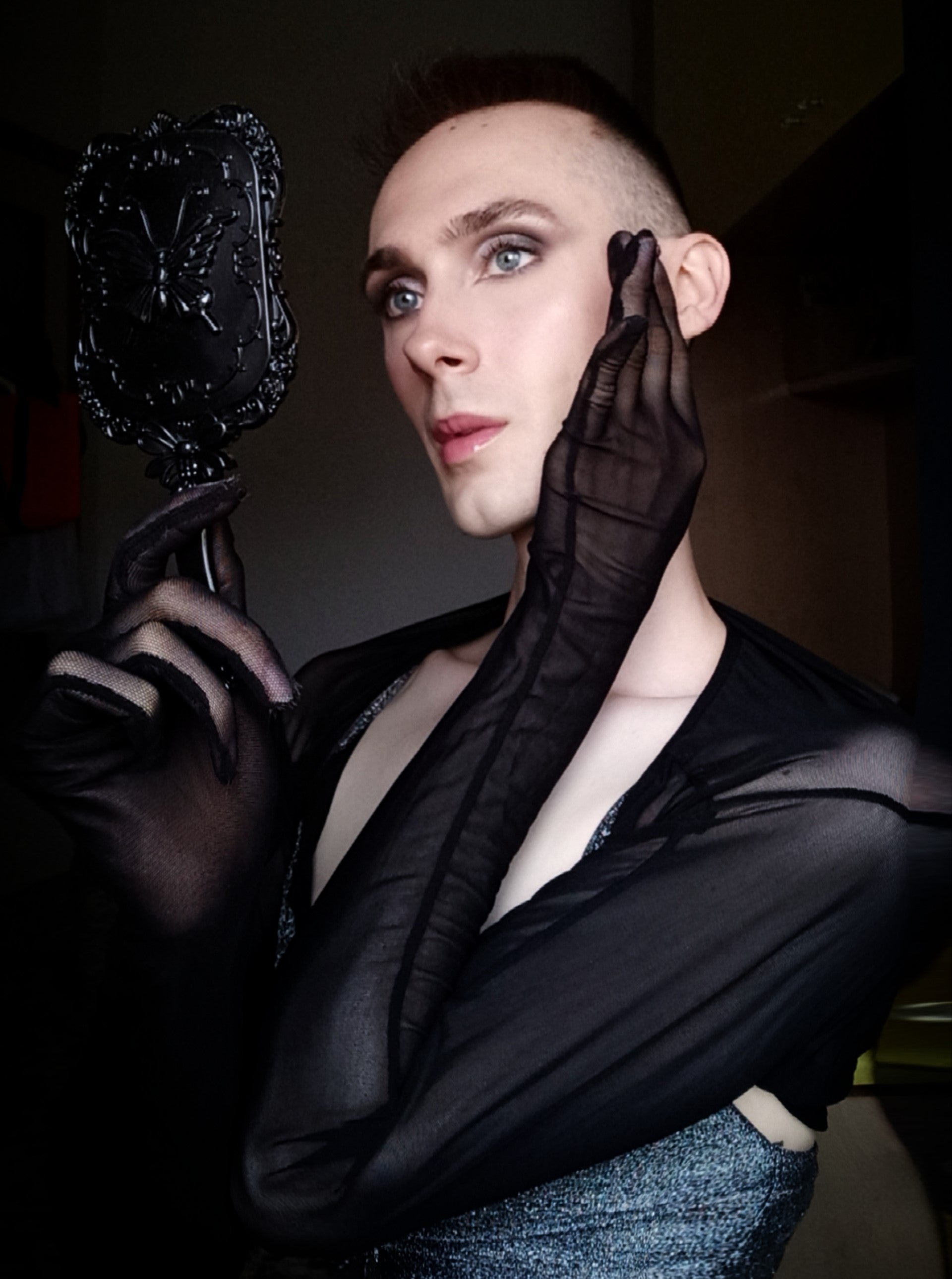 Our Content Creator and Influencer Michael Beccalli, or just Mike, mirroring himself with an elegant hand mirror, and a stunning makeup.