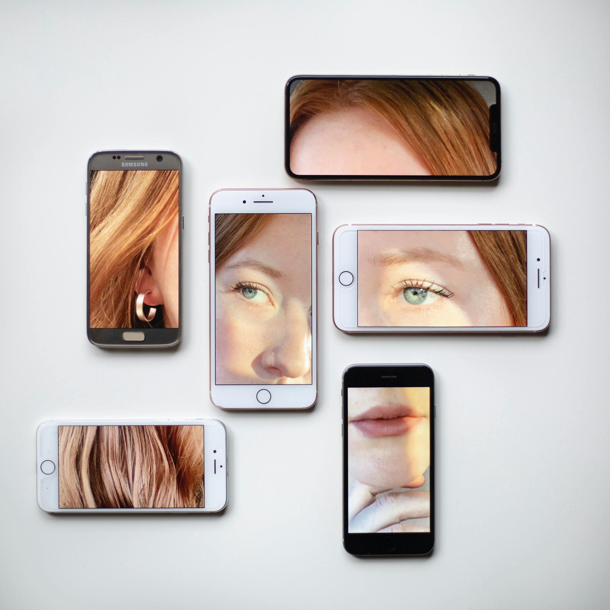 Closeups of a woman's beauty features displayed on different phone screens, reflecting the fusion of beauty and technology, symbolizing the future of the beauty tech industry.