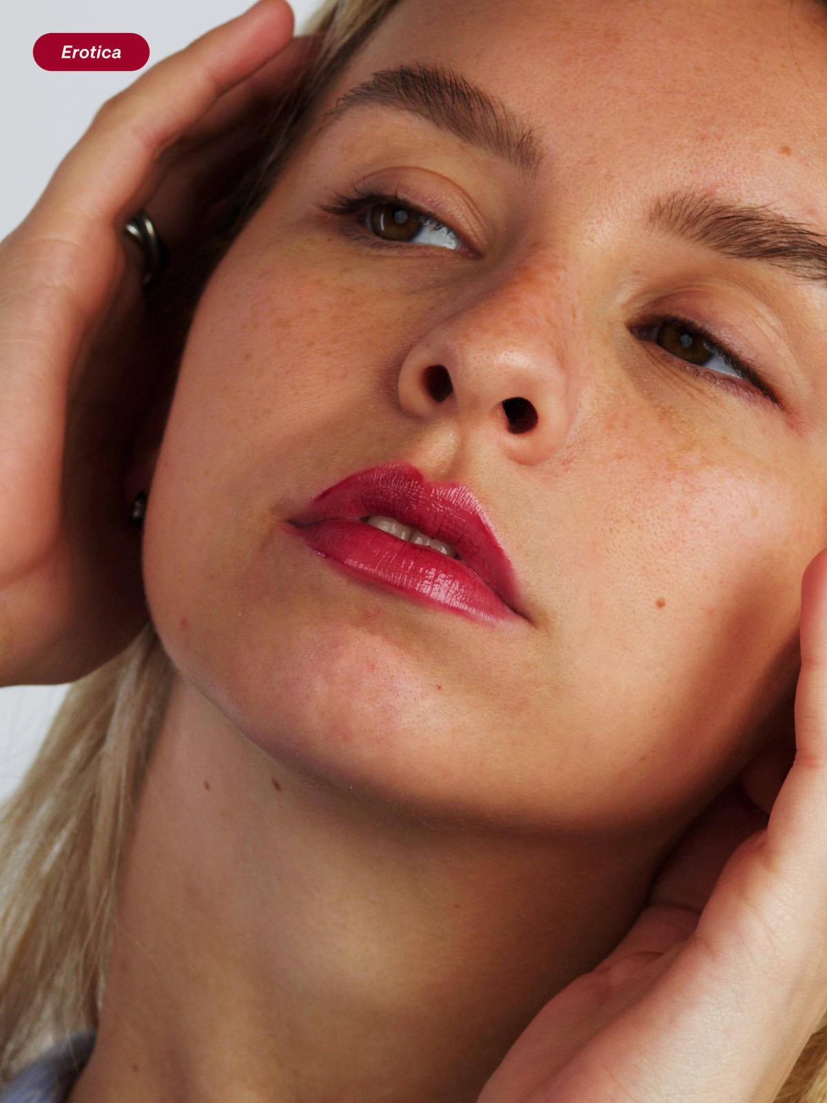 Woman wearing the 2 in 1 vegan hydrating and plumping lip oil and balm in Erotica shade, for tinted, glossy and plump lips