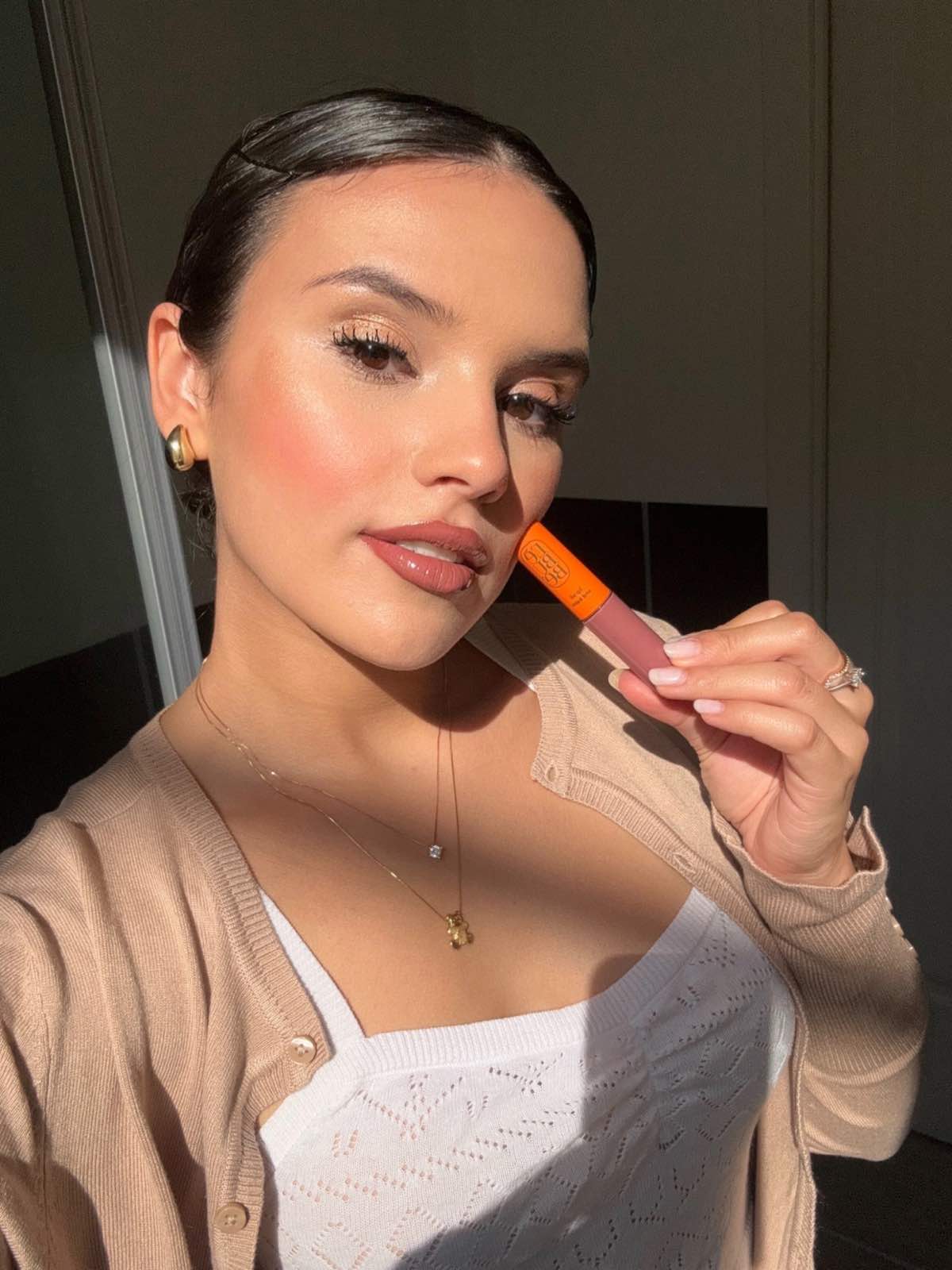 Woman wearing Lebubè lip treatment in First Kiss for nude lips. A vegan and natural hydrating tinted lip balm for dry lips