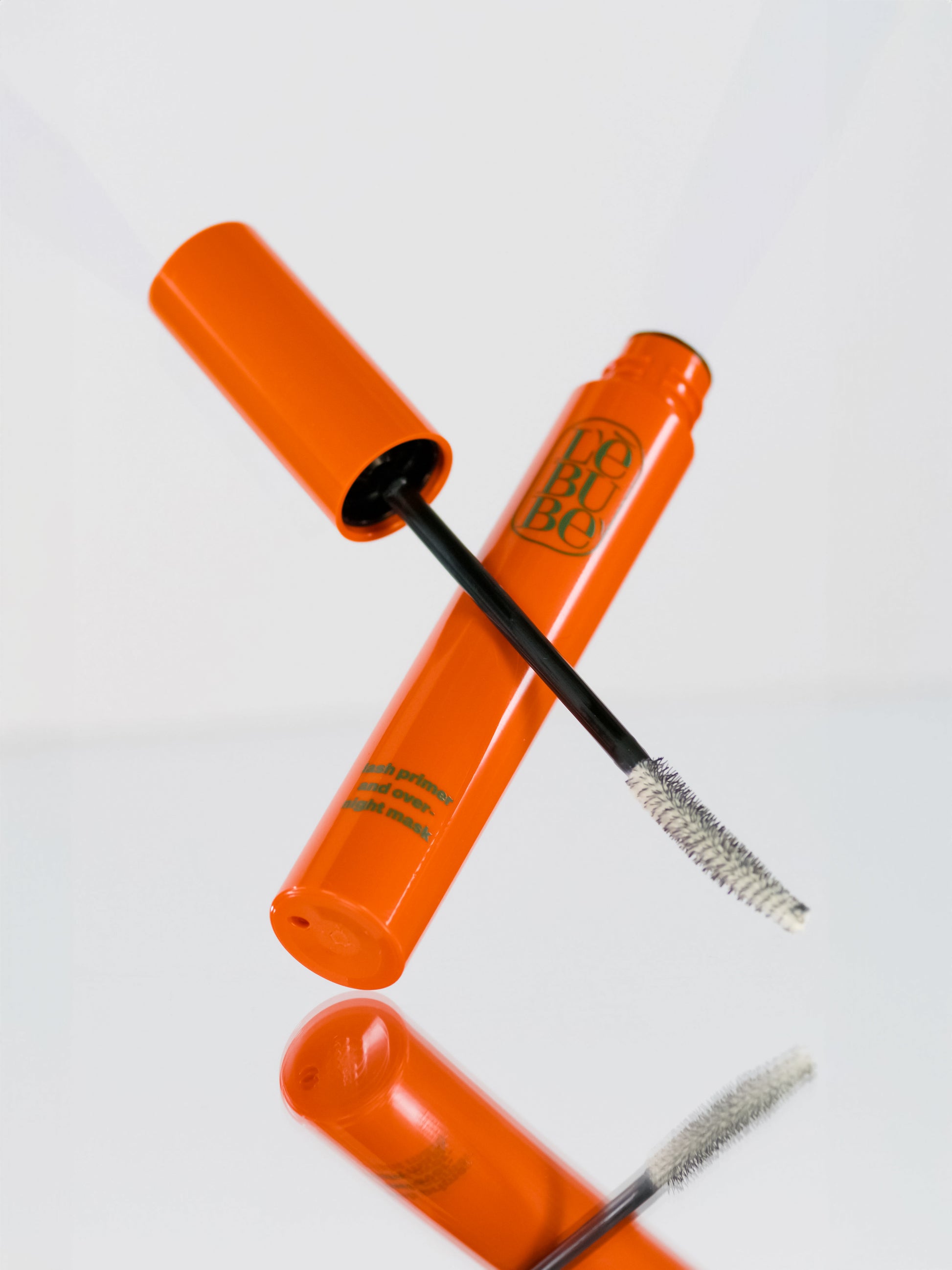 Lebubè Lash Primer and Overnight Mask: volume booster lash primer and lash mask. Wand crossed with tube, front view.