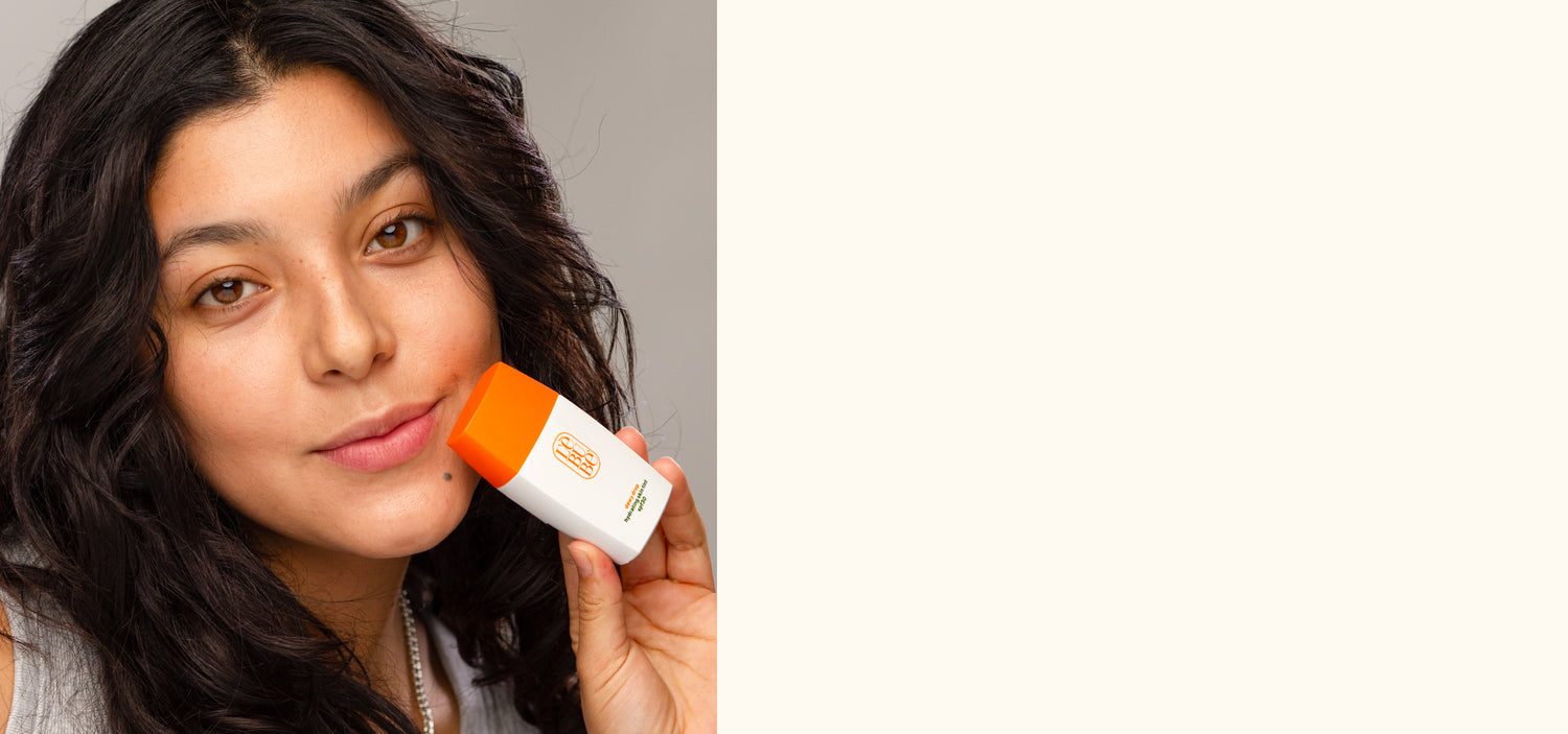 Woman with medium skin wearing and holding Lebubè skin tint with sheer to medium coverage with skincare benefits 