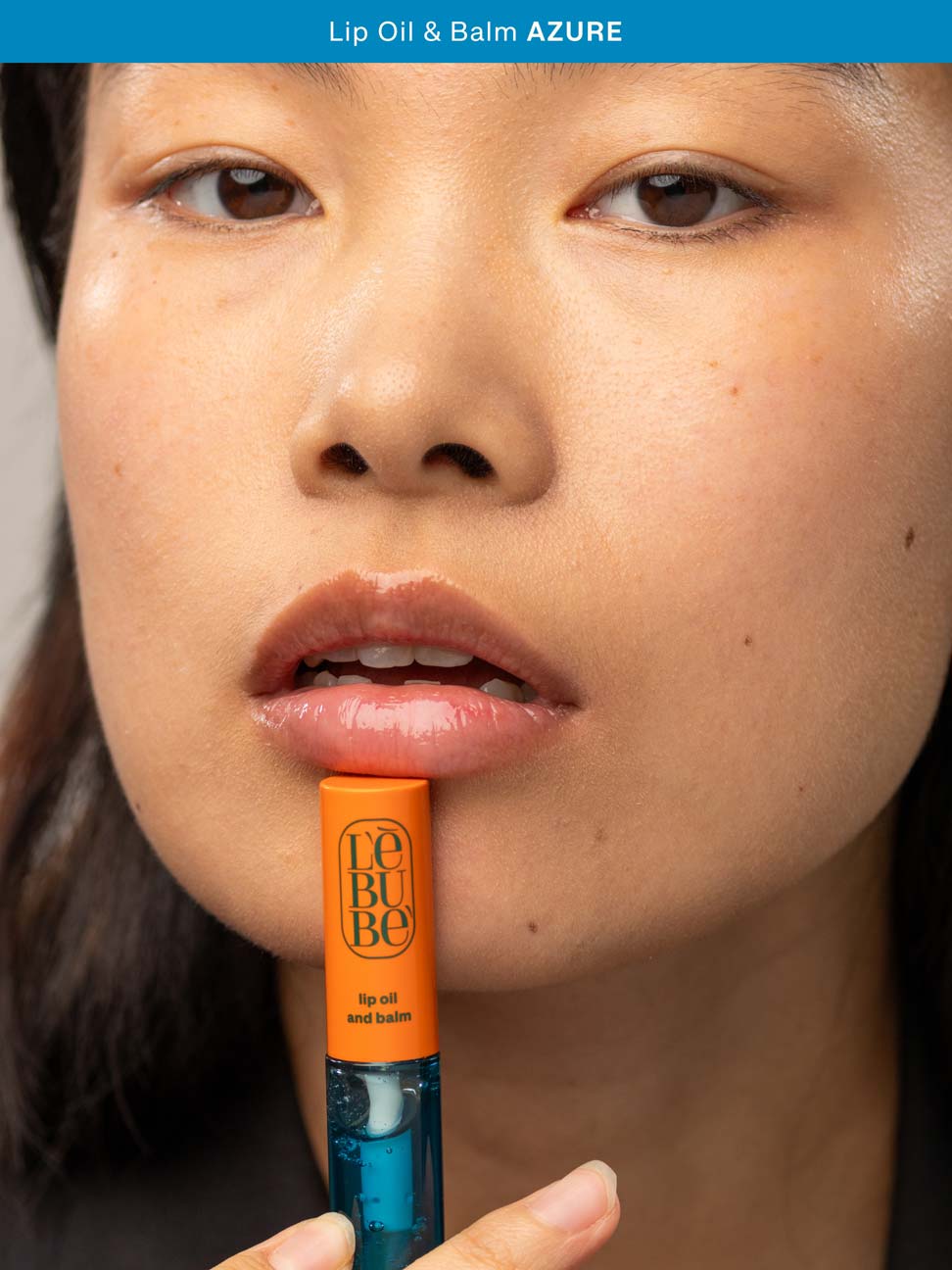 Woman wearing Lebubè hydrating lip gloss in Azure for a natural and glossy look on her lips. From Lebubè vegan Halal hybrid cosmetics.