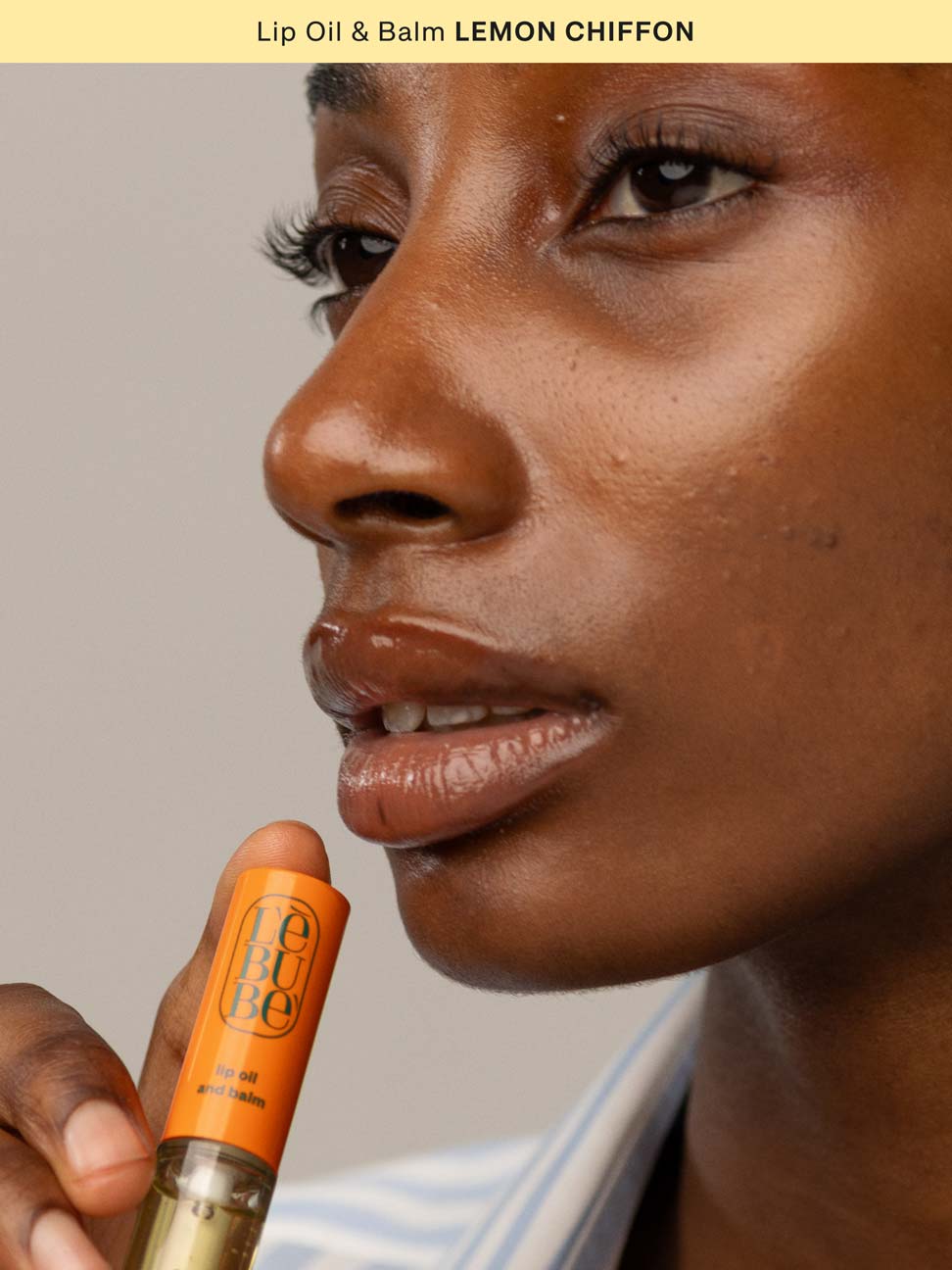 Woman wearing Lebubè Lip Oil and Balm in Lemon Chiffon, a natural 2 in 1 nourishing lip oil and hydrating balm for lips