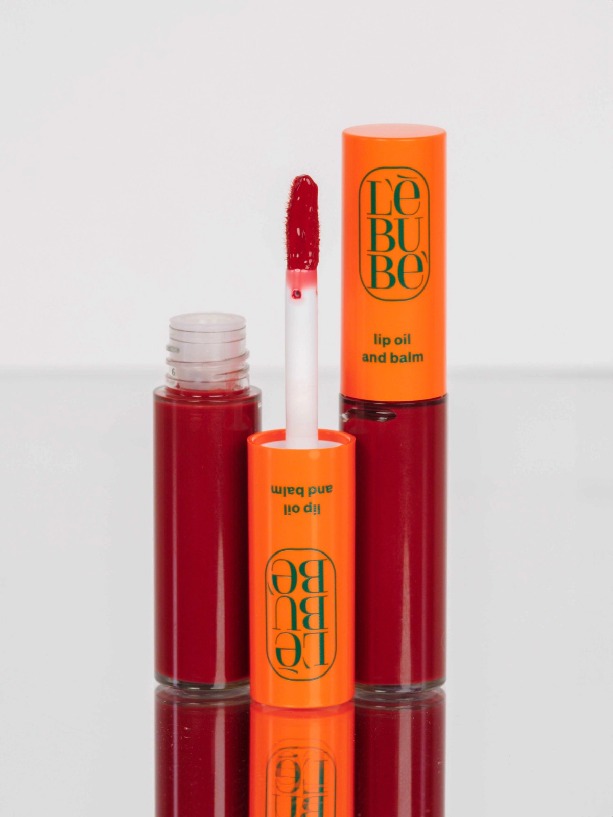 Lebubè Tinted Lip Oil and Balm: zoomed-in front view of Pomegranate shade. Plumping tinted lip oil with hyaluronic acid