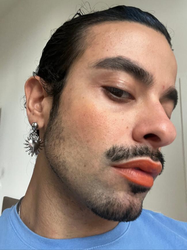 Man wearing Lebubè orange Lip and Cheek, on cheeks and lips, showing the orange blush & orange lipstick for sun-kissed effect