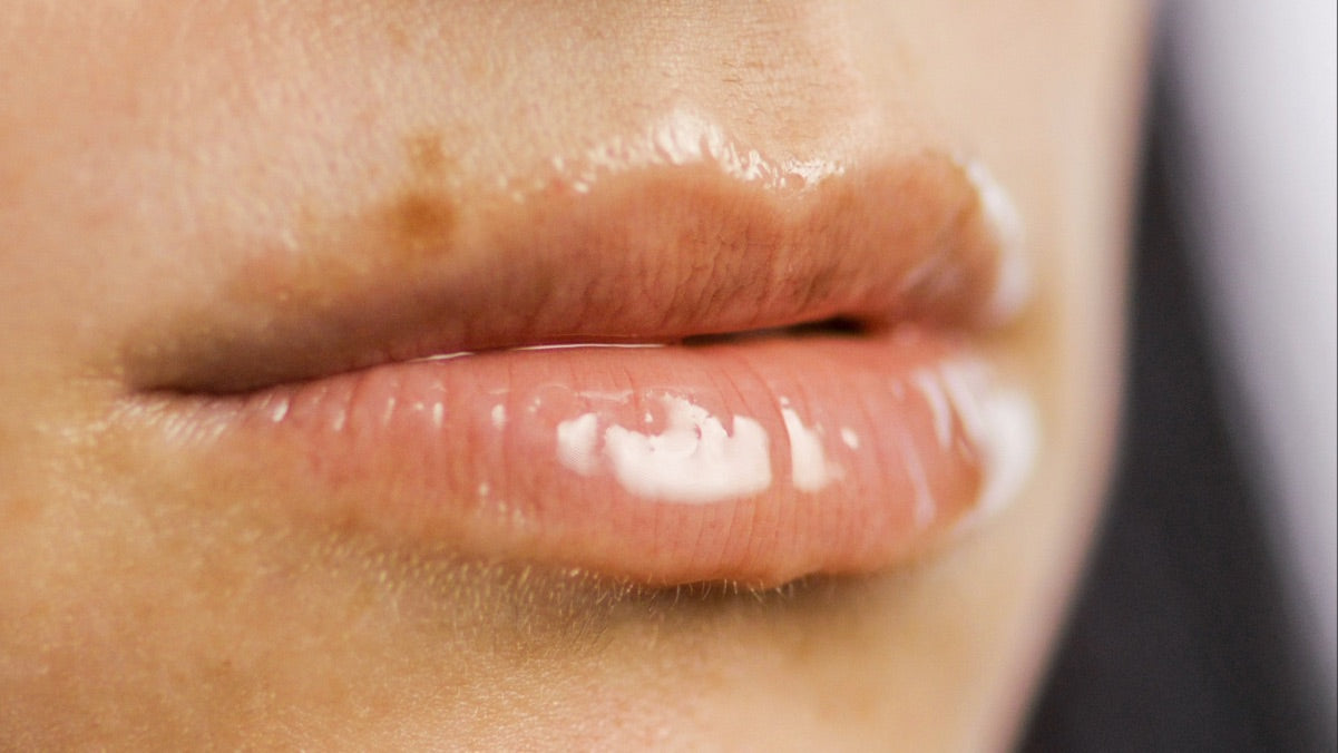 Close-up of a woman's lips with Lebubè nourishing, repairing and hydrating lip treatment for dry lips, with skincare actives
