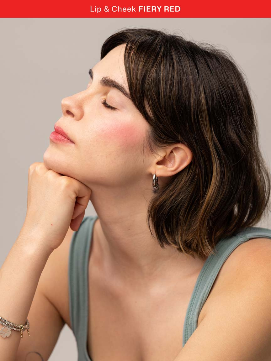 Woman wearing Lebubè multifunctional vegan and Halal lipstick and blush with natural ingredients in Fiery Red, with bold look