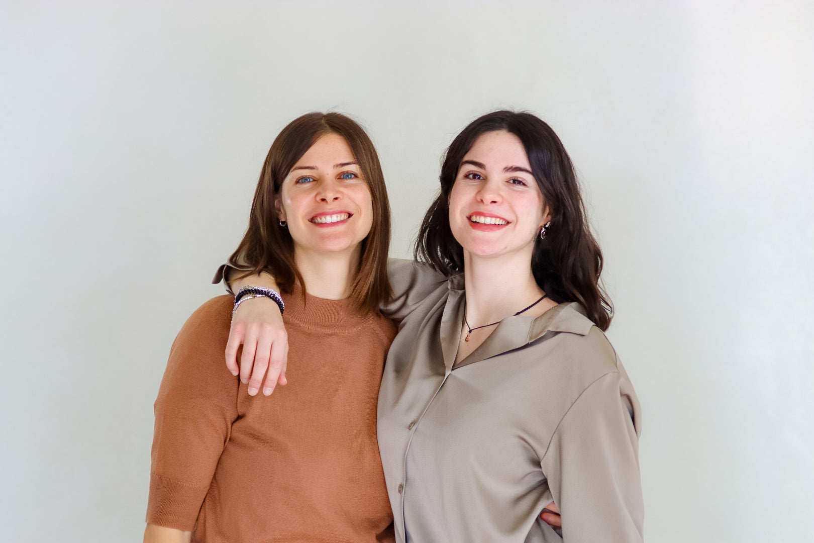Mirta and Vittoria, sisters and co-founders of Lebubè vegan and natural hybrid cosmetics, smiling and hugging each other
