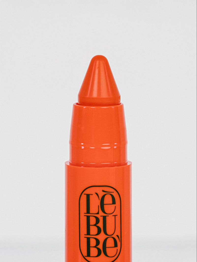 Lebubè Lip and Cheek: zoomed-in front view of Orange Lebube shade. 2 in 1 Halal, vegan and natural blush and lipstick.
