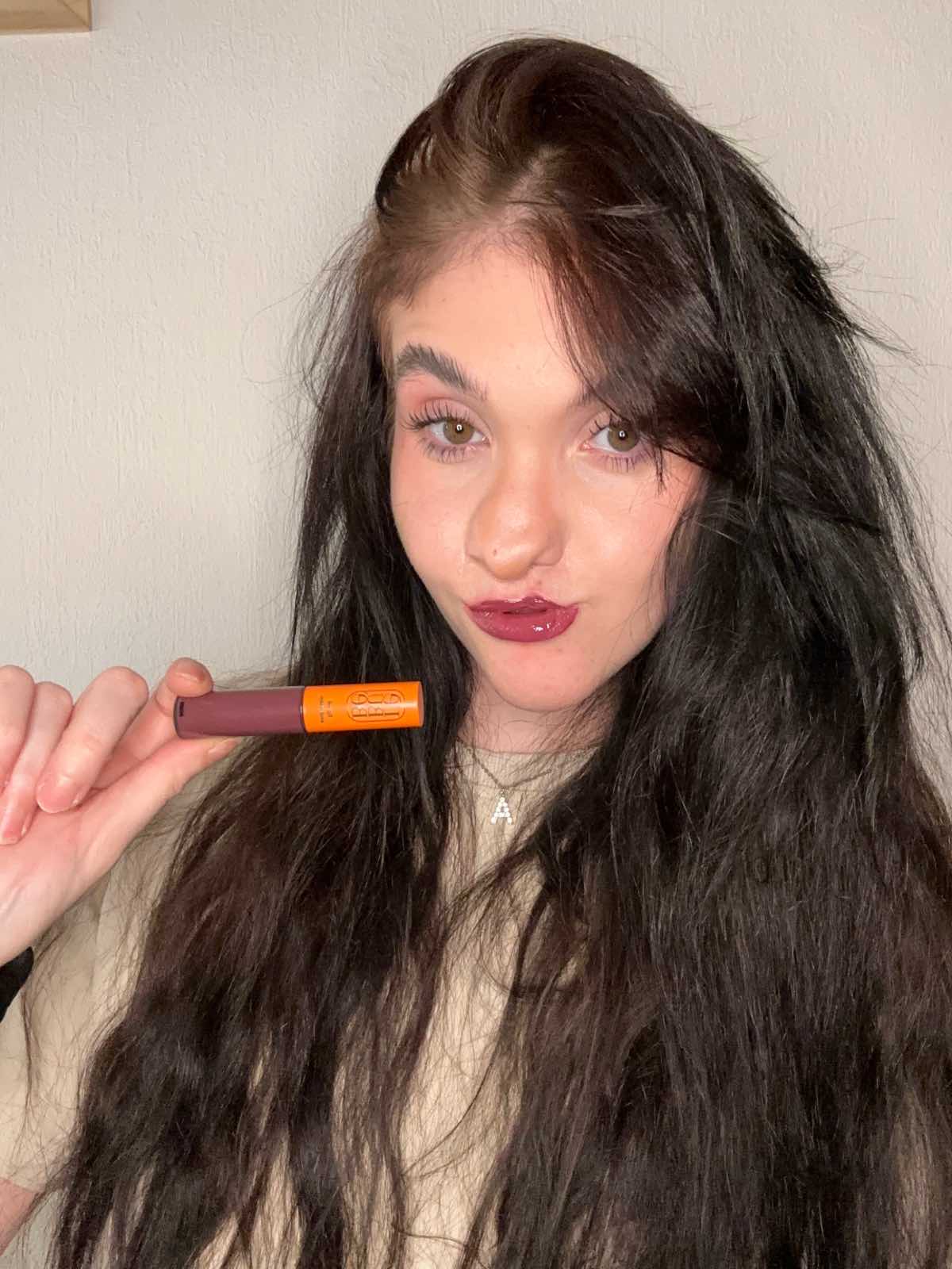 Woman wearing Lebubè plumping tinted lip oil and balm in Wine shade, for hydrated, plumper and softer lips