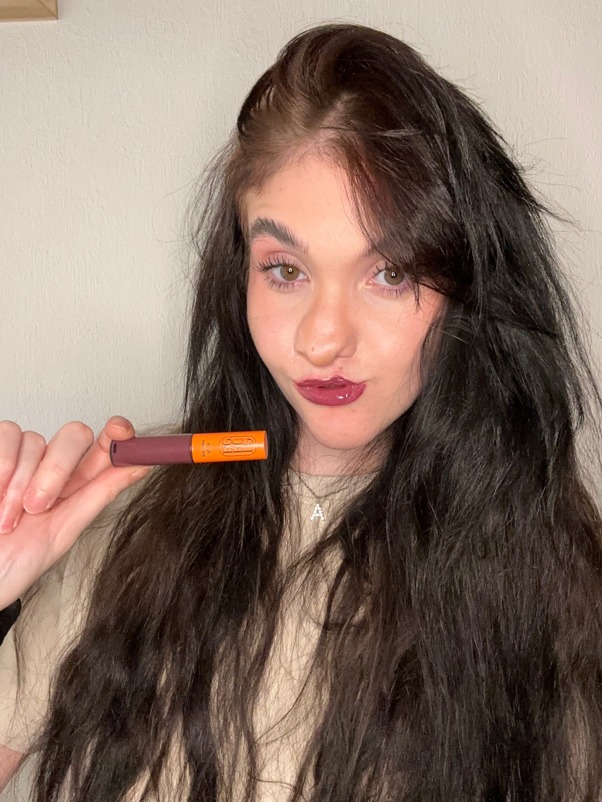 Woman wearing Lebubè plumping tinted lip oil and balm in Wine shade, for hydrated, plumper and softer lips