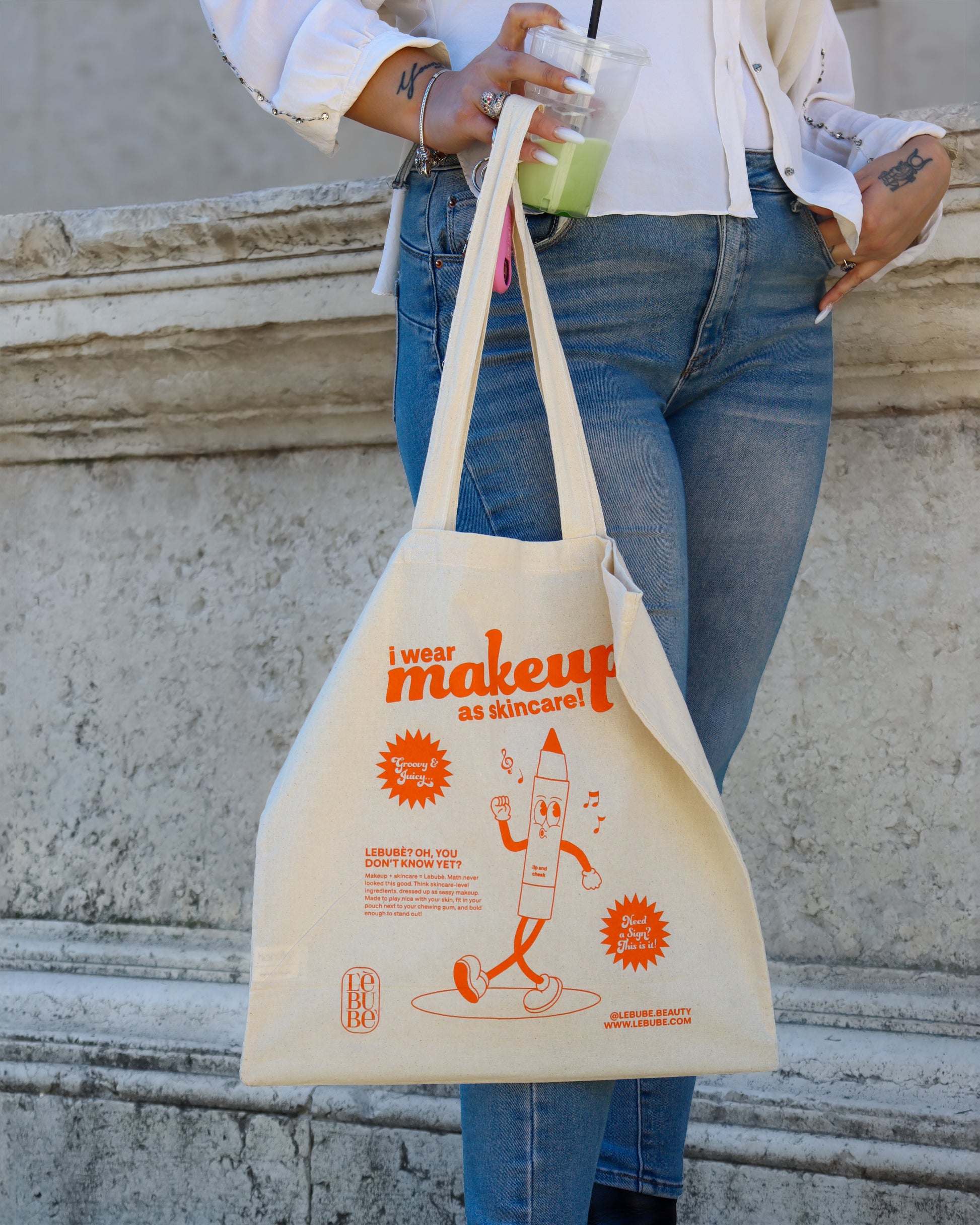 Eco-friendly Lebubè tote bag in orange print, durable and lightweight for everyday use