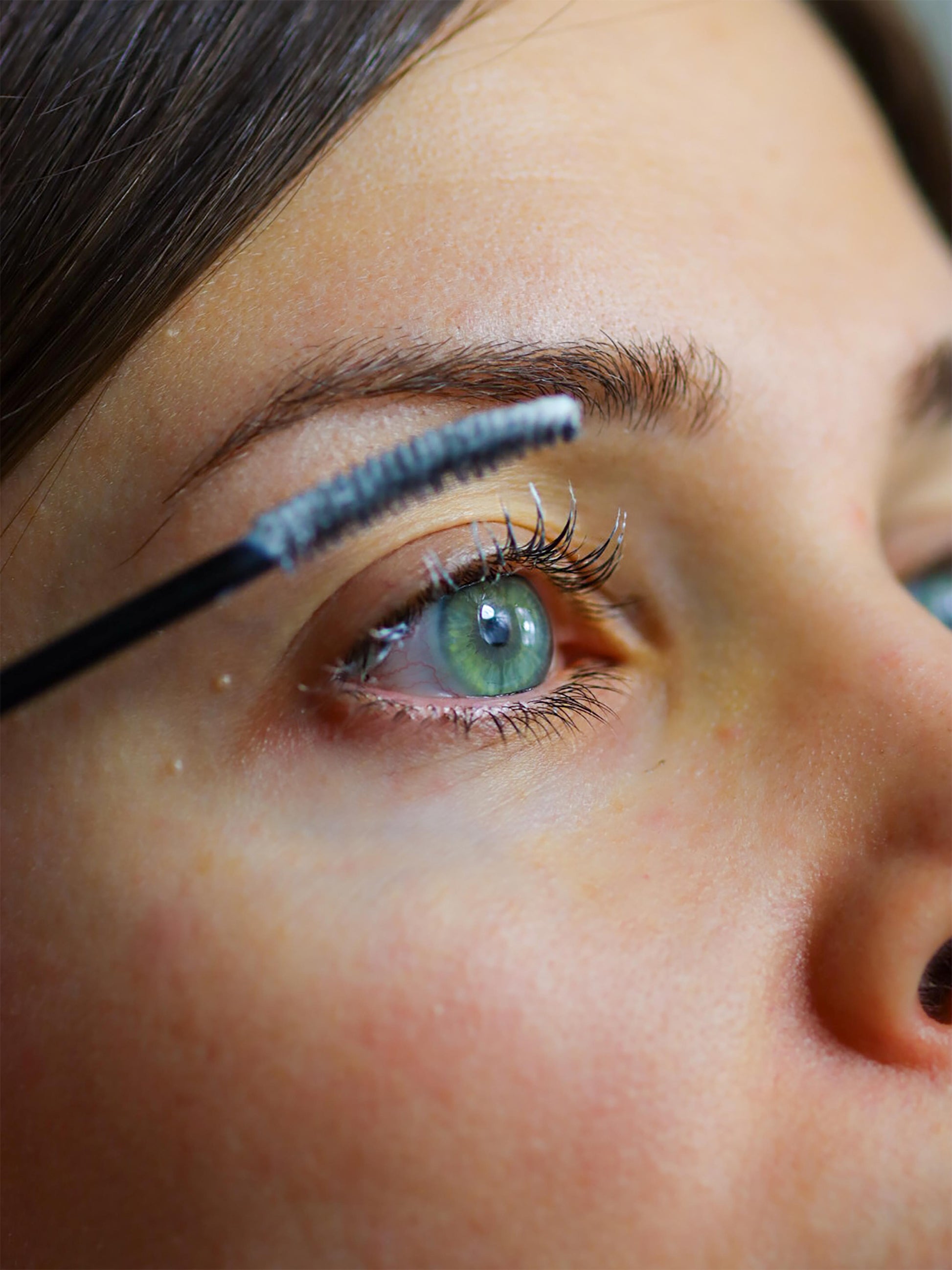 Zoom in on an eye with Lash Primer & Overnight Mask applied to lashes, for lash volume booster and lash volumizing treatment
