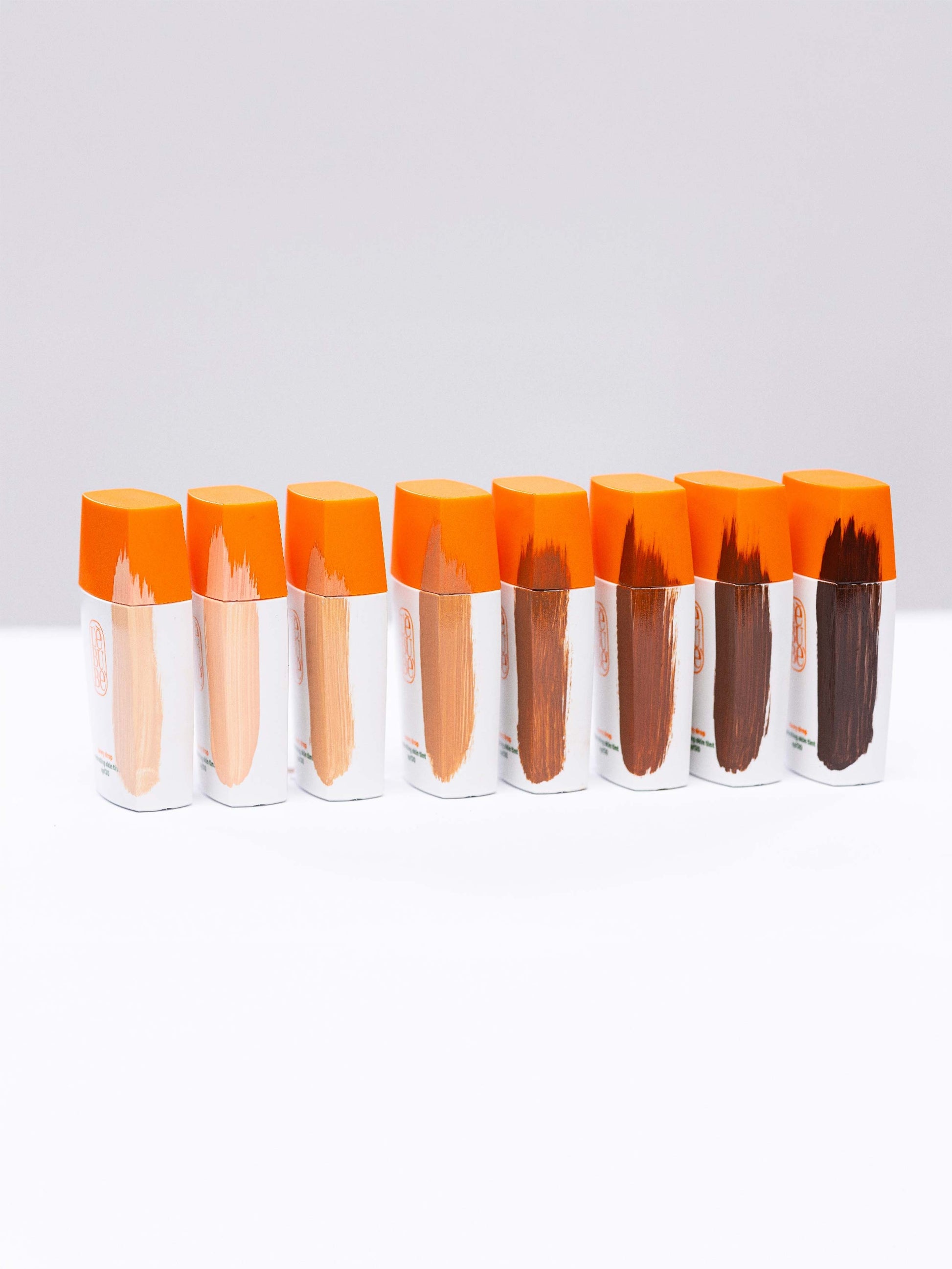 Lebubè hydrating skin tint with spf in 8 shades displayed in a row, showing the inclusive shade range from fair to rich deep