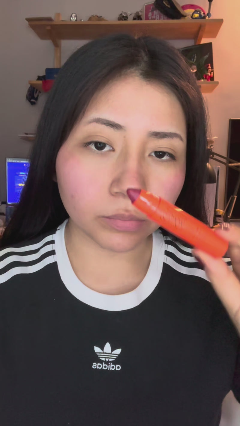 Woman applying Lip and Cheek in Rubia Rose and Lip Oil and Balm in Orchid Pink for a glossy lip finish and nourishing effect