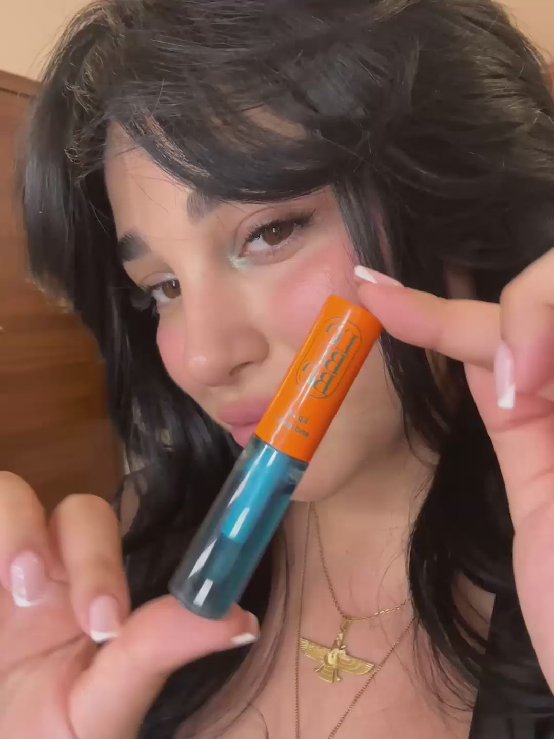 Load video: Woman applying the Halal, vegan, natural and hydrating Lip Balm in Azure, for lip care and treatment to protect dry lips