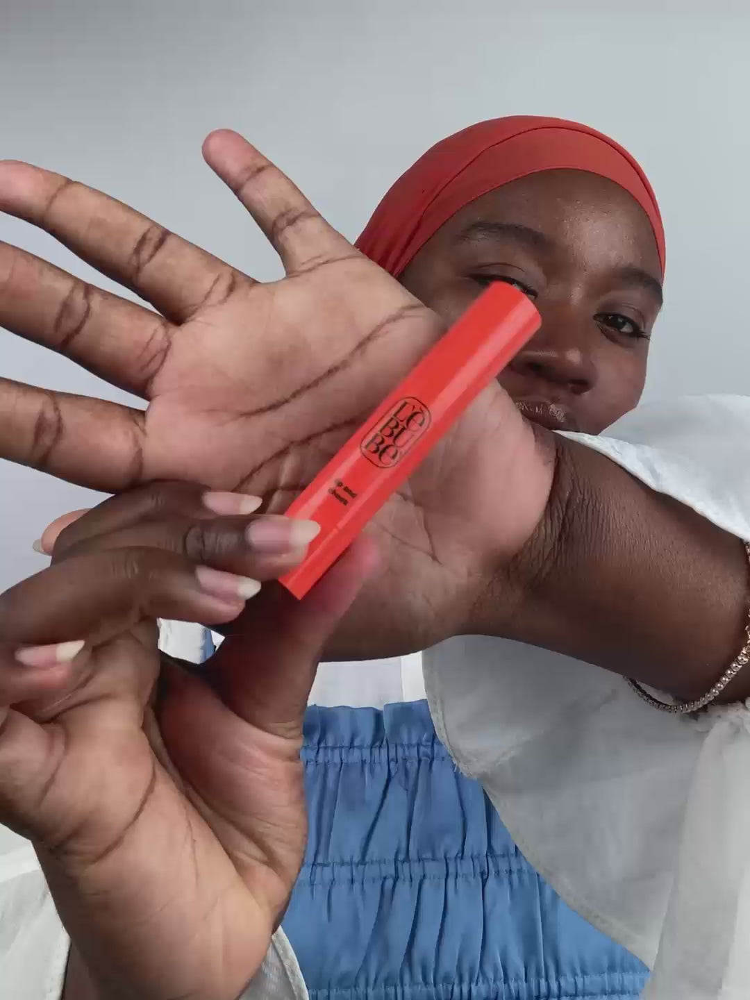 Load video: Woman applying Lebubè Lip and Cheek lipstick and blush in Rubia Rose and hydrating cream highlighter for a glowy, dewy effect