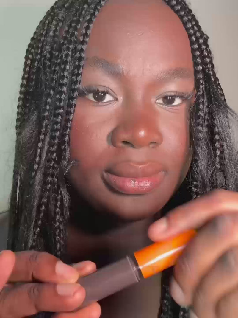 Woman applying the grey lip oil for cooler lips. A vegan, natural lip oil with skincare actives for nourished and glossy lips