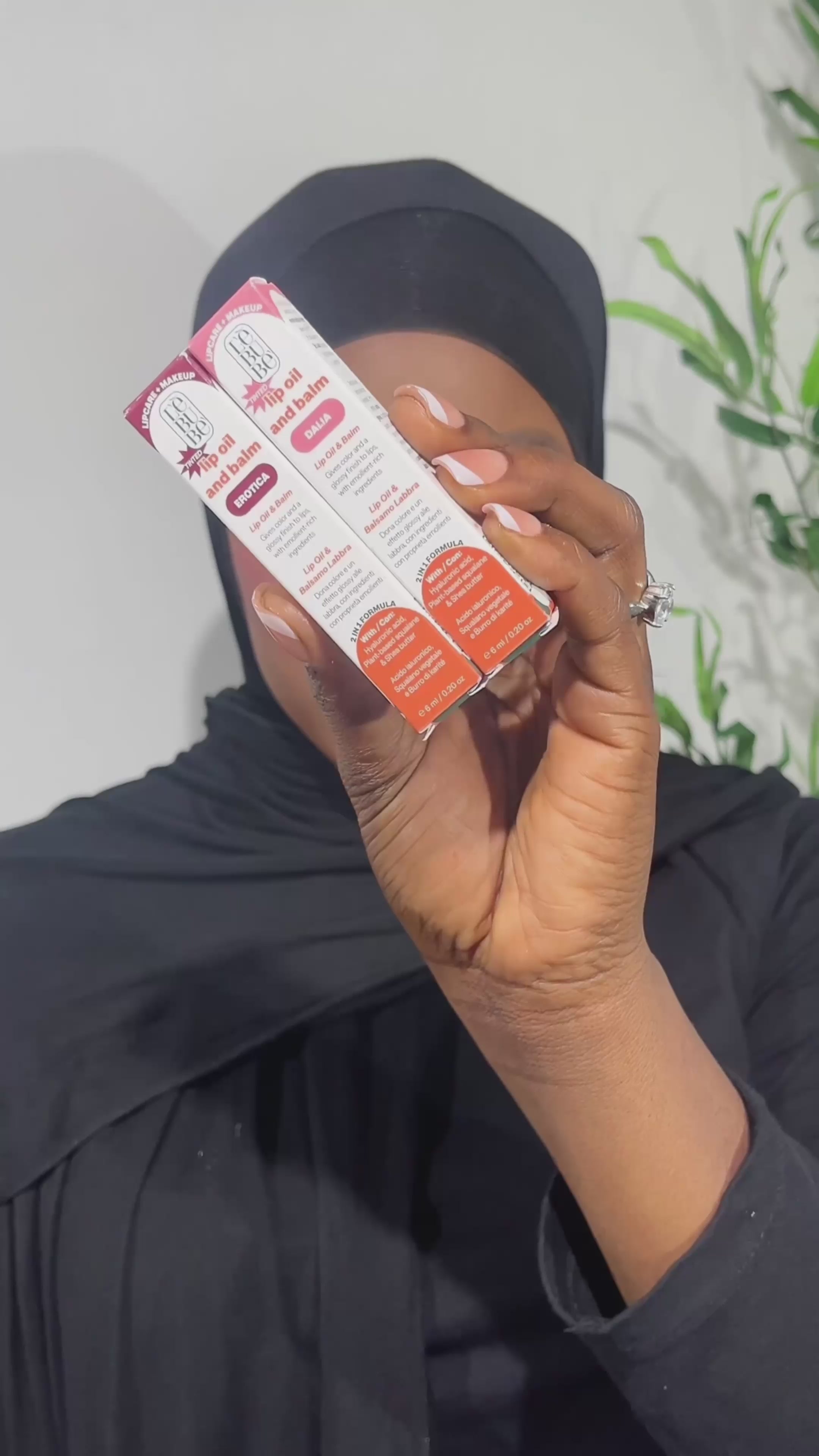 Load video: Woman wearing Dalia and Erotica shades of Lebubè Tinted Lip Oil, for glossy and hydrated lips. From Lebubè hybrid cosmetics
