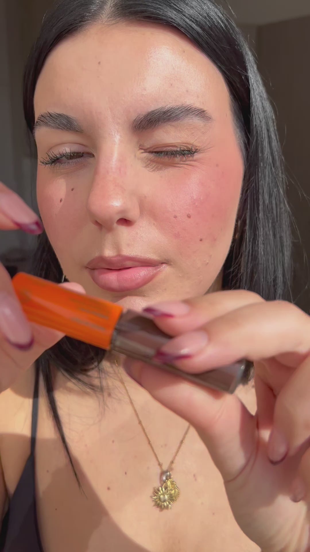 Load video: Woman applying the vegan tinted lip treatment for dry lips in Bitter Chocolate. Lips look plumper, softer and more hydrated