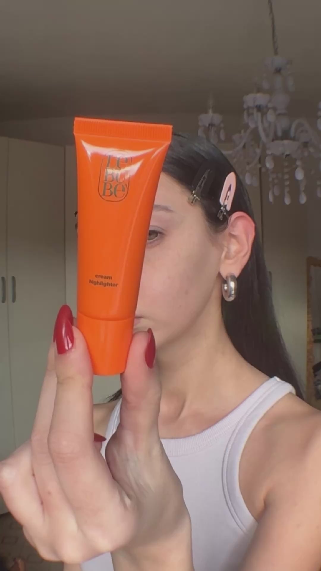 Load video: Woman wearing Lebubè cheek hybrid cosmetics: Lip and Cheek, 2 in 1 lipstick and blush, and hydrating cream highlighter
