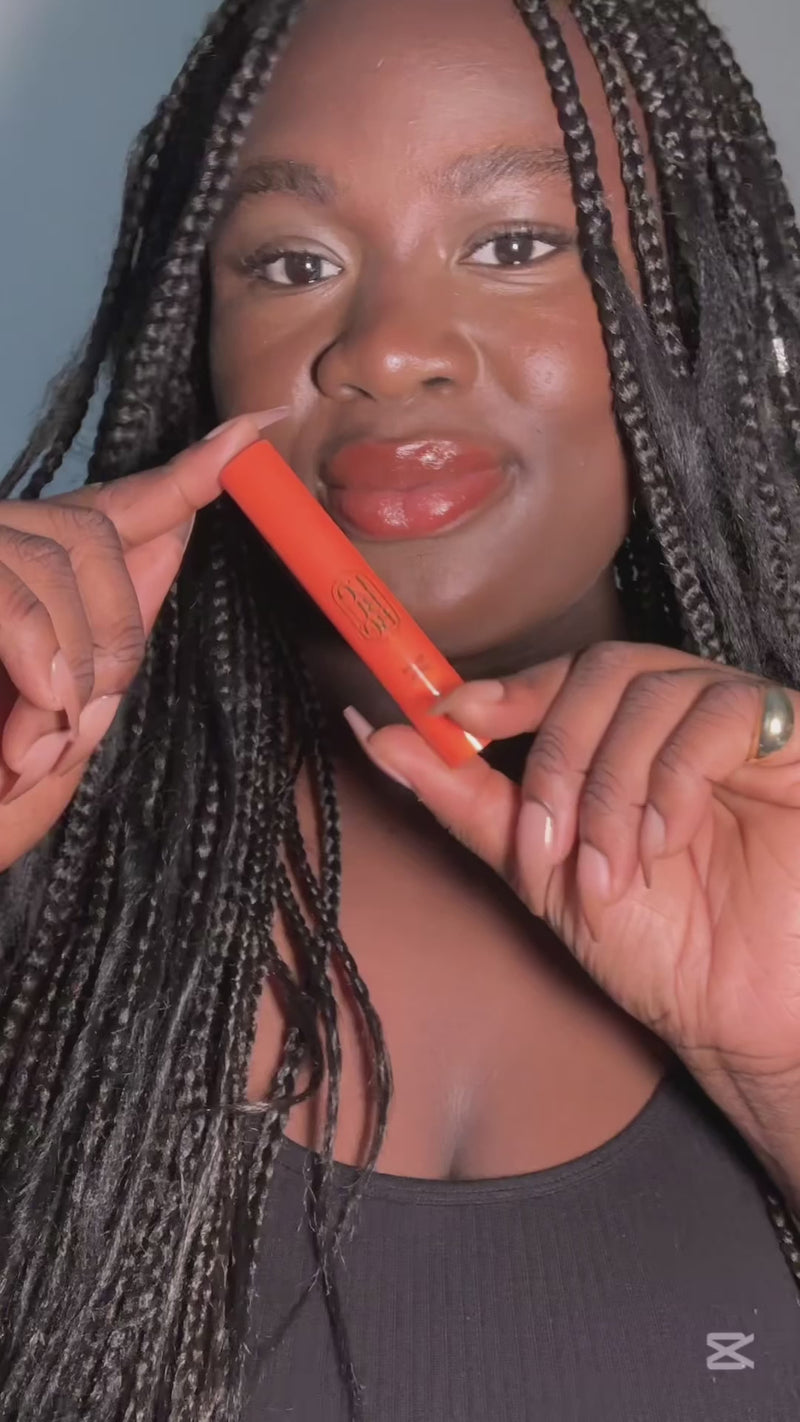 Woman applying Lip and Cheek in Fiery Red, a lipstick + blush crayon from Lebubè vegan makeup with skincare benefits