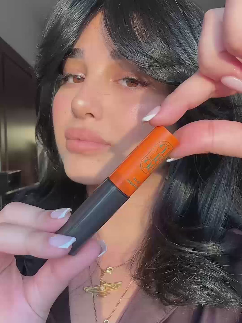 Woman wearing Lebubè Tinted Lip Oil and Balm in Enigma, a plumping gloss with hyaluronic acid for hydration and nourishment
