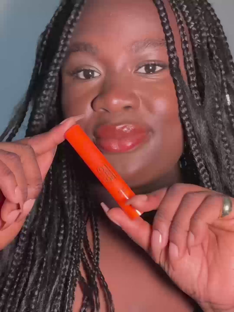 Woman applying Lip and Cheek in Fiery Red, a lipstick + blush crayon from Lebubè vegan makeup with skincare benefits